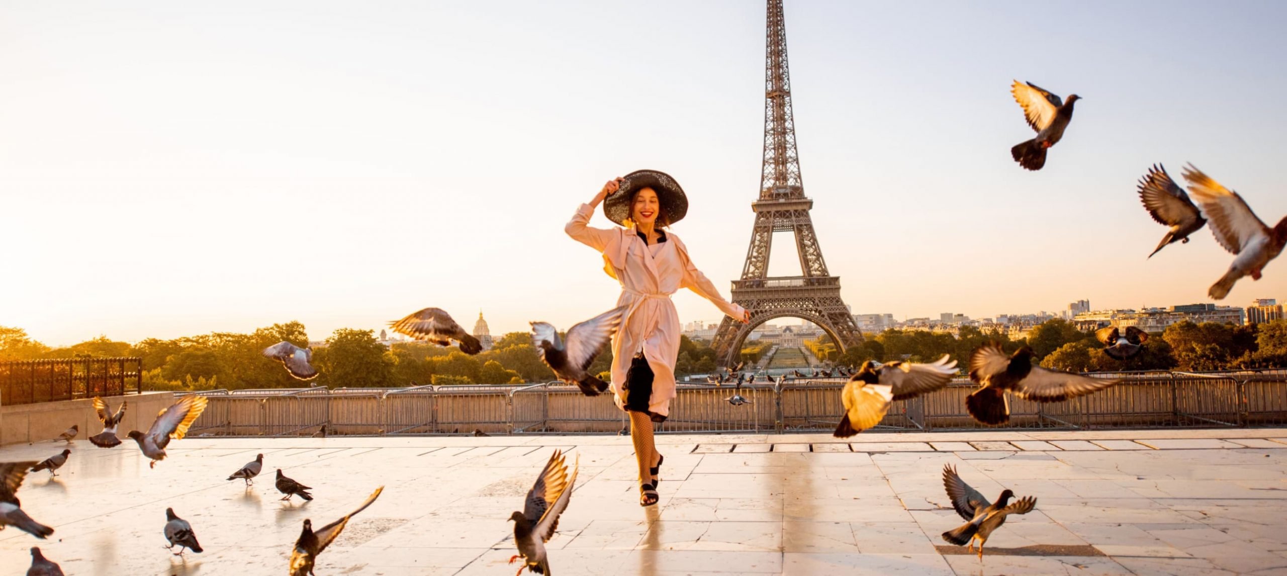 Best time to visit Paris - a woman in front of Eiffel Tower