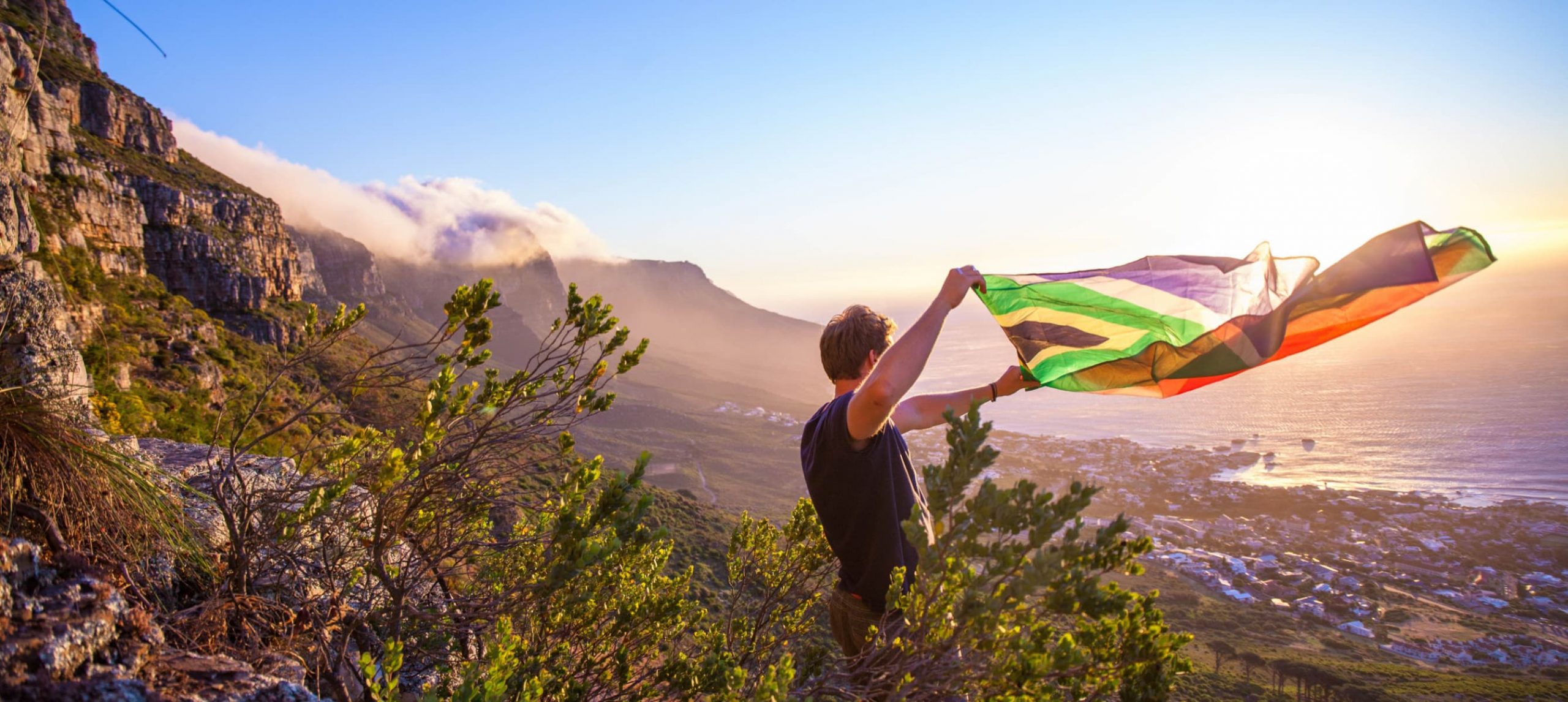 a man holding a South Africa flag