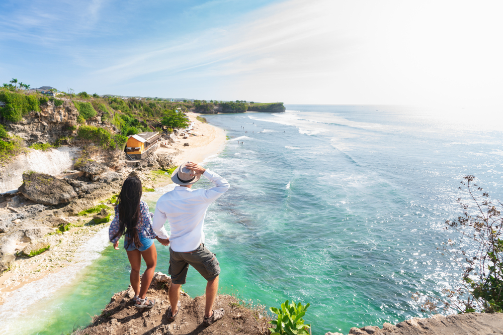 HikersWithBackpacksRelaxingOnTopOfAMountainAnd | CuddlyNest Travel Blog