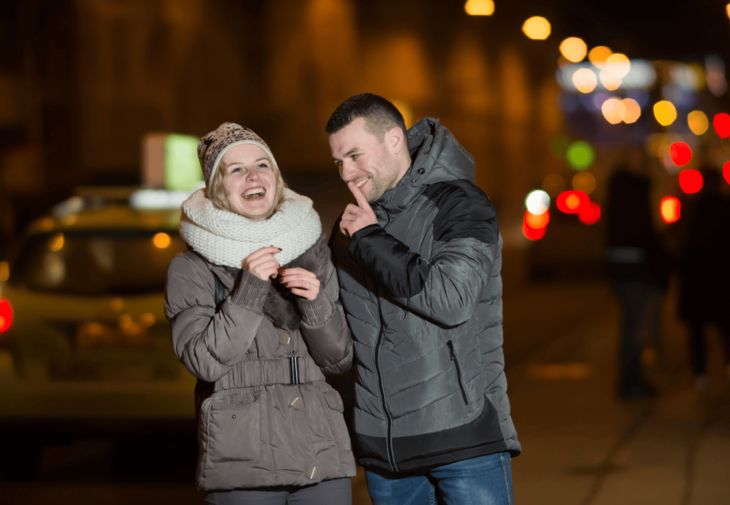 Romantic couple walking in city night. New Year’s Eve in Barcelona