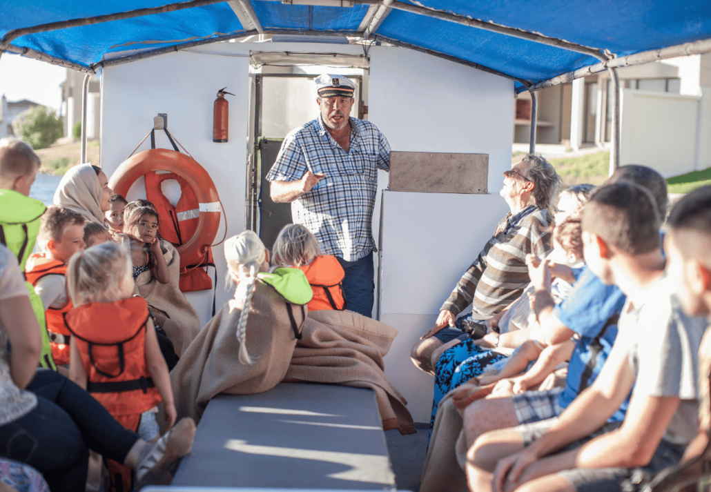 underrated cool summer destinations in the US Captain talking to tourists on boat trip