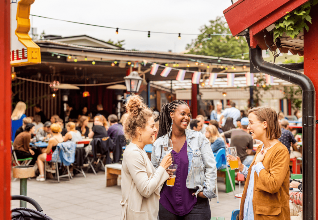 Young female friends relaxing in beer garden