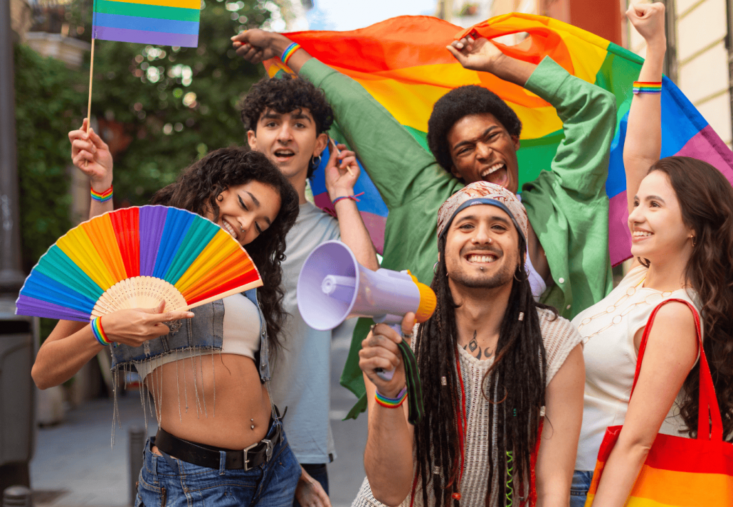 Young activists protesting for lgbtq plus rights waving rainbow flags and using megaphone