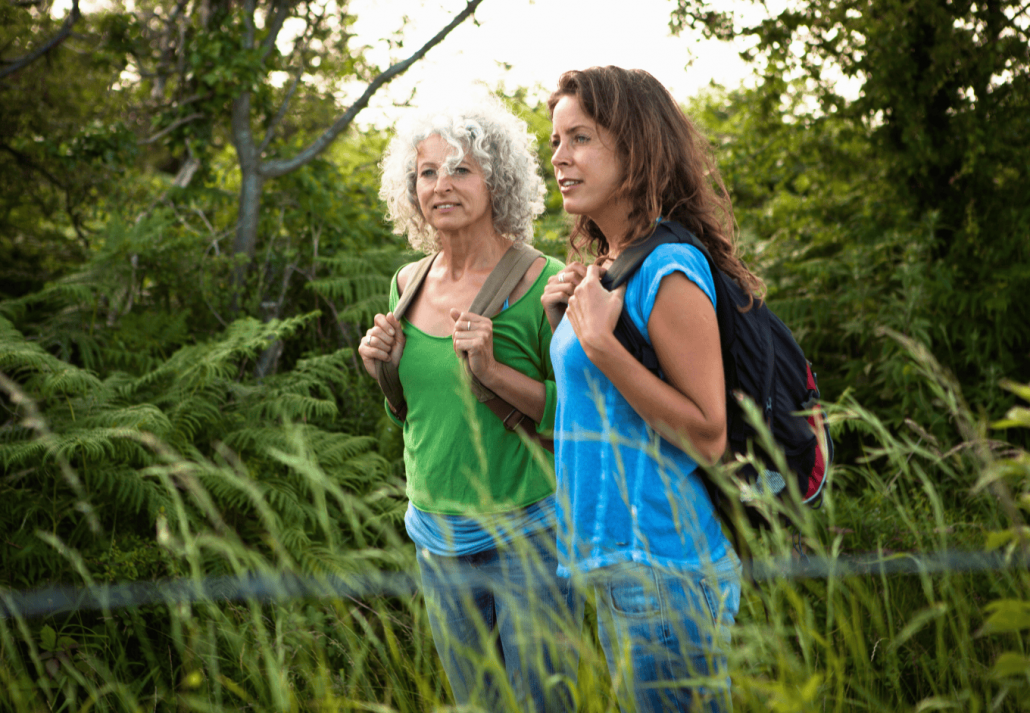mother daughter enjoying a peaceful hike through lush greenery