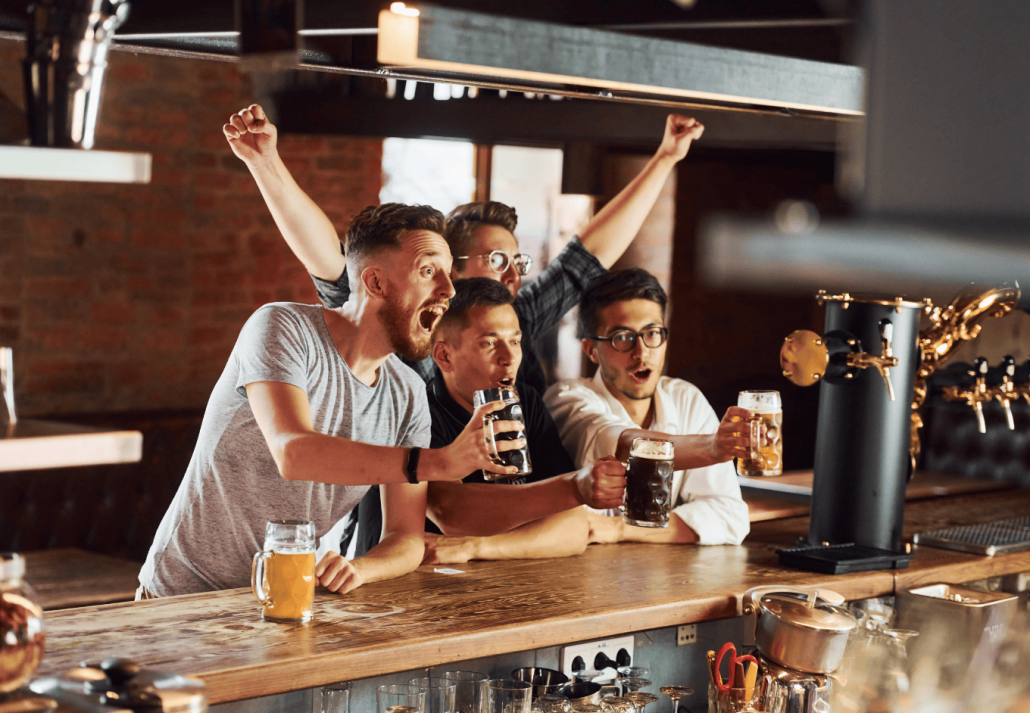 People in casual clothes sitting in the pub and drinking beer