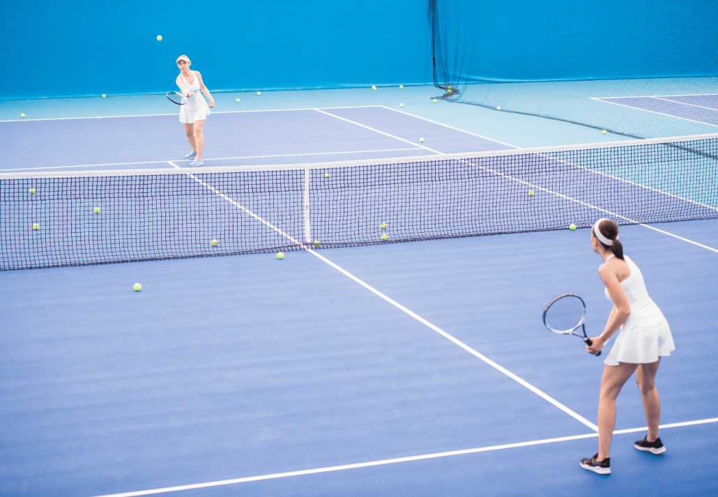 Two Sportswomen Playing Tennis in Court