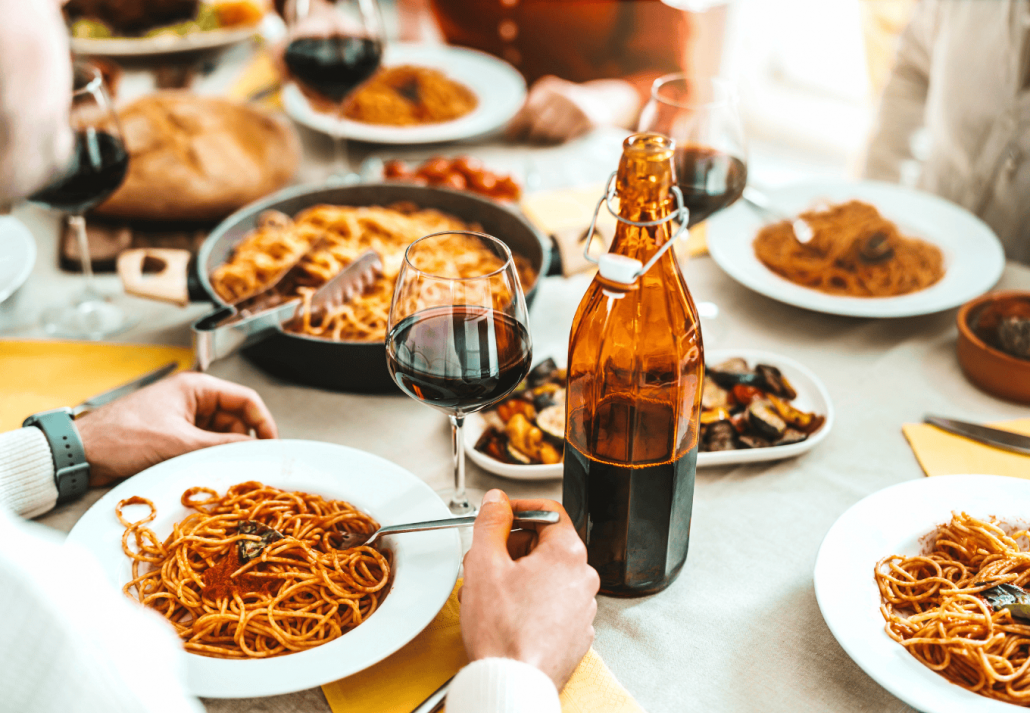 Group of friends having a pasta dinner party at restaurant