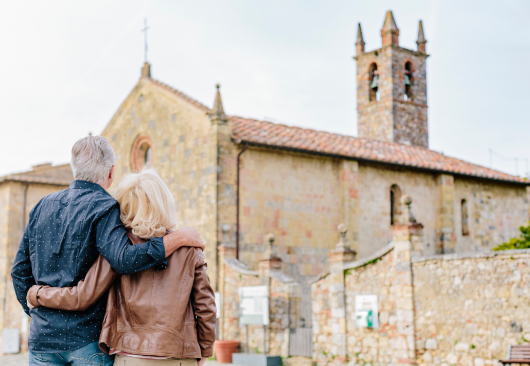 Rear view of tourist couple looking at church, day trips from barcelona by train