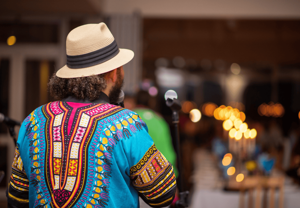 
Musician with african print shirt performing shot from behind