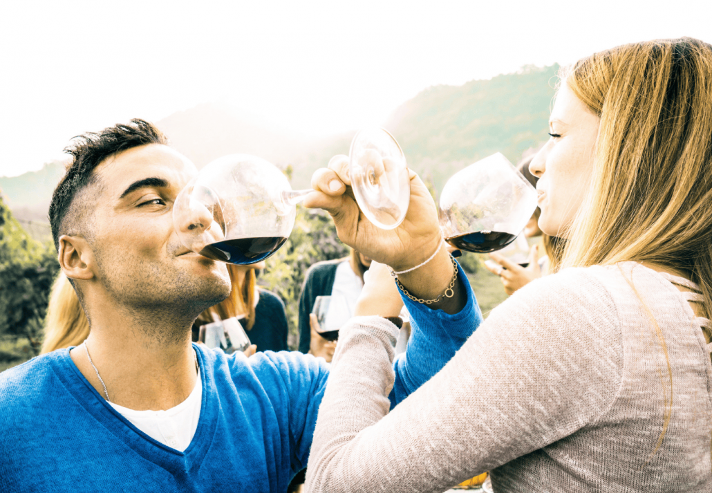 Happy couple in love toasting red wine at vineyard farmhouse. santa barbara wine tours
