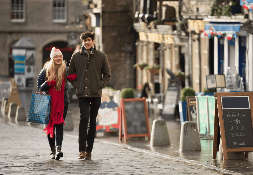 A young couple shop in the Grassmarket in Edinburgh, Scotland