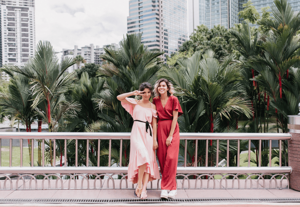 Full-length portrait of well-dressed female friends enjoying trip Singapore