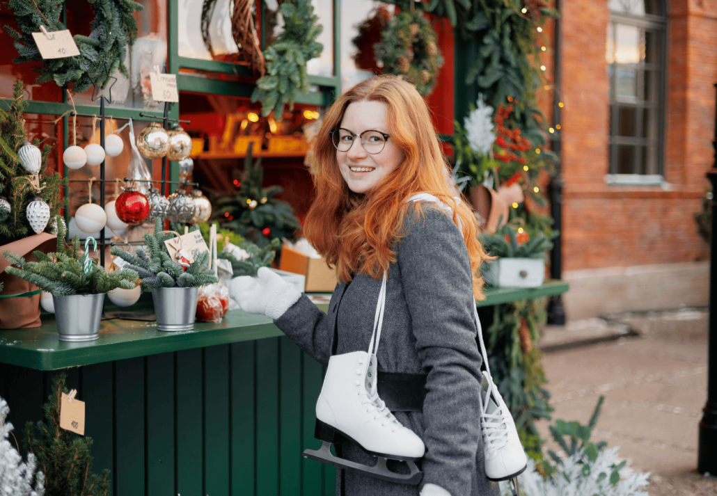 woman is walking in park or on ice rink. happy woman at Christmas market buying gifts and having fun