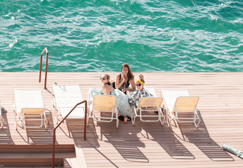 Happy family on boat dock at lake