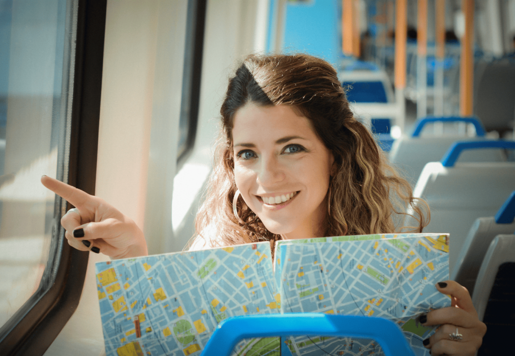 Young Woman With Map Traveling By The Train. Enjoying Travel Concept.