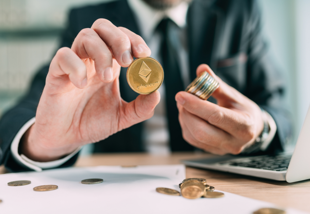 Ethereum cryptocurrency trader concept, closeup of coins and businessman working in background