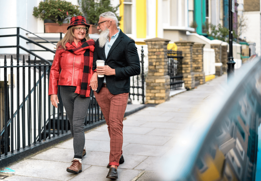 Happy senior couple walking holding hand in Notting Hill in London City